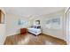 Bright bedroom featuring hardwood floors, white daybed, and natural light from two large windows at 140 Sage Cir, Crystal Beach, FL 34681