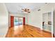 Bedroom boasts wood floors, ceiling fan, access to a bathroom and sliding doors leading to the pool at 140 Sage Cir, Crystal Beach, FL 34681