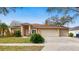 Traditional-style home with a 3-car garage, well-kept lawn, and established landscaping in a desirable neighborhood at 140 Sage Cir, Crystal Beach, FL 34681