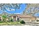 Charming single-story home boasts a meticulously landscaped front yard and a spacious three-car garage at 140 Sage Cir, Crystal Beach, FL 34681
