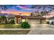 Inviting single-story home featuring a well-manicured lawn and a convenient three-car garage at 140 Sage Cir, Crystal Beach, FL 34681