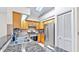 Well-lit kitchen featuring granite counters, stainless steel appliances, and wood cabinets at 140 Sage Cir, Crystal Beach, FL 34681