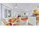 Open concept living area with hardwood floors, with views into the dining and kitchen spaces at 140 Sage Cir, Crystal Beach, FL 34681