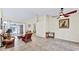 Bright living room featuring tile flooring, a ceiling fan, and glass sliding doors to the outdoor area at 140 Sage Cir, Crystal Beach, FL 34681