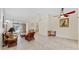 Spacious living room with tile flooring, comfortable seating, and sliding door access to outdoor patio at 140 Sage Cir, Crystal Beach, FL 34681