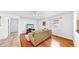 Bright living room with hardwood floors, large windows, and a comfortable sofa at 140 Sage Cir, Crystal Beach, FL 34681