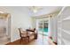 Bright office area featuring wood flooring, a ceiling fan, and glass sliding doors to the outdoor pool area at 140 Sage Cir, Crystal Beach, FL 34681