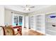 Bright office area featuring wood flooring, a ceiling fan, and view to the pool at 140 Sage Cir, Crystal Beach, FL 34681