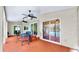 Covered patio with tile flooring and ceiling fans, offering views of the screened-in pool area at 140 Sage Cir, Crystal Beach, FL 34681