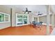 Covered patio featuring tiled flooring, ceiling fans, and outdoor seating with a view of the pool at 140 Sage Cir, Crystal Beach, FL 34681