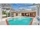 Open air patio with screened-in pool, perfect for enjoying sunny afternoons at 140 Sage Cir, Crystal Beach, FL 34681