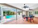 Covered patio with screened-in pool, and dining set for outdoor entertaining at 140 Sage Cir, Crystal Beach, FL 34681
