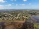 Extensive aerial view of neighborhoods near a lake and the ocean beyond at 1472 Ivydale Rd, Spring Hill, FL 34606
