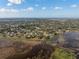 Wide aerial landscape view of the extensive neighborhoods near a lake and the ocean beyond at 1472 Ivydale Rd, Spring Hill, FL 34606