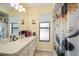 Bathroom with shower/tub combination, tile floor, and long vanity with solid surface counter at 1472 Ivydale Rd, Spring Hill, FL 34606