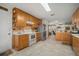 Bright kitchen featuring wooden cabinets and a view of the open concept living and office space at 1472 Ivydale Rd, Spring Hill, FL 34606