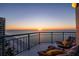 Serene sunset view from balcony with comfortable seating, perfect for enjoying coastal tranquility at 1520 Gulf Blvd # Ph1 1901, Clearwater Beach, FL 33767