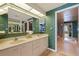 Bright bathroom with double sinks, vanity, large mirror, and stylish wallpaper at 1520 Gulf Blvd # Ph1 1901, Clearwater Beach, FL 33767