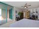 Comfortable bedroom with balcony access, ceiling fan, and built-in bookshelves for added convenience at 1520 Gulf Blvd # Ph1 1901, Clearwater Beach, FL 33767