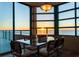 Bright dining area featuring modern table and chairs with sunset ocean views from expansive windows at 1520 Gulf Blvd # Ph1 1901, Clearwater Beach, FL 33767