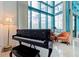 Living room with piano and floor to ceiling windows with ocean view at 1520 Gulf Blvd # Ph1 1901, Clearwater Beach, FL 33767