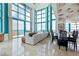 Expansive living room with floor-to-ceiling windows, an adjacent dining area, and panoramic ocean views at 1520 Gulf Blvd # Ph1 1901, Clearwater Beach, FL 33767