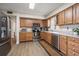 Well-lit kitchen with stainless steel appliances, wood cabinets, and stylish tile flooring at 1718 Evans Dr, Clearwater, FL 33759