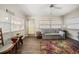 This is a cozy living room with a ceiling fan, a sofa, and colorful flooring at 1718 Evans Dr, Clearwater, FL 33759