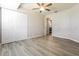 Cozy bedroom with a ceiling fan, closet, and wood-look flooring at 18663 Kerrville Cir, Port Charlotte, FL 33948