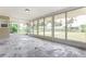 Bright sunroom with wall-to-wall windows overlooking the outdoors, flooding the space with natural light at 18663 Kerrville Cir, Port Charlotte, FL 33948
