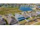 Aerial view of a fenced backyard with green lawn near community pond at 2111 Roanoke Springs Dr, Ruskin, FL 33570