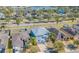 Aerial view of a two-story home with neutral paint, two-car garage, and landscaping, near a community lake at 2111 Roanoke Springs Dr, Ruskin, FL 33570