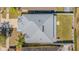 Aerial view of a well-maintained roof with seamless gutters, a fenced yard, and a manicured lawn at 2111 Roanoke Springs Dr, Ruskin, FL 33570