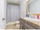 A cozy bathroom with a large mirror, shower and vanity at 2111 Roanoke Springs Dr, Ruskin, FL 33570