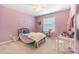 Charming bedroom with soft pink walls, carpet and natural light with a creative atmosphere at 2111 Roanoke Springs Dr, Ruskin, FL 33570
