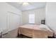 Simple bedroom with carpet, a closet with sliding doors, and a bright window at 2111 Roanoke Springs Dr, Ruskin, FL 33570