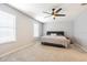 Bright bedroom with a ceiling fan and a large window, offering plenty of natural light at 2111 Roanoke Springs Dr, Ruskin, FL 33570