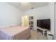 Cozy bedroom featuring neutral walls, carpet, and a TV setup with ample storage at 2111 Roanoke Springs Dr, Ruskin, FL 33570