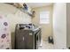 The laundry room features modern washer and dryer, with storage and a convenient space for chores at 2111 Roanoke Springs Dr, Ruskin, FL 33570