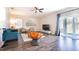 Open-concept living room with hardwood floors, modern furniture, and large glass sliding door at 2111 Roanoke Springs Dr, Ruskin, FL 33570