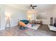 Bright living room with hardwood floors, fan, neutral walls, and stylish modern furniture at 2111 Roanoke Springs Dr, Ruskin, FL 33570