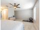 Spacious main bedroom with a ceiling fan, carpeted floor, and exercise equipment at 2111 Roanoke Springs Dr, Ruskin, FL 33570
