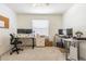Home office with modern desks, multiple monitors, and comfortable office chair at 2111 Roanoke Springs Dr, Ruskin, FL 33570