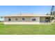 Expansive backyard with green lawn, providing ample space for outdoor activities and relaxation at 28 Caddy Rd, Rotonda West, FL 33947