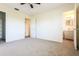 Spacious bedroom with carpet, ceiling fan, and access to bathroom and closet at 28 Caddy Rd, Rotonda West, FL 33947