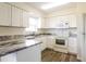 Well-equipped kitchen boasting ample counter space, white cabinets, and modern appliances at 28 Caddy Rd, Rotonda West, FL 33947