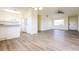 Open-concept living space with sleek flooring, connecting kitchen and living areas for seamless entertaining at 28 Caddy Rd, Rotonda West, FL 33947
