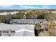 Aerial view of a complex with multiple units, lush landscaping, and a sunny atmosphere at 300 Glennes Ln # 203, Dunedin, FL 34698