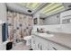 Bathroom featuring nautical themed shower curtain, vanity, and tiled floor at 300 Glennes Ln # 203, Dunedin, FL 34698