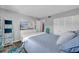 Comfortable bedroom featuring closet space, a dresser with a TV, and nautical theme at 300 Glennes Ln # 203, Dunedin, FL 34698